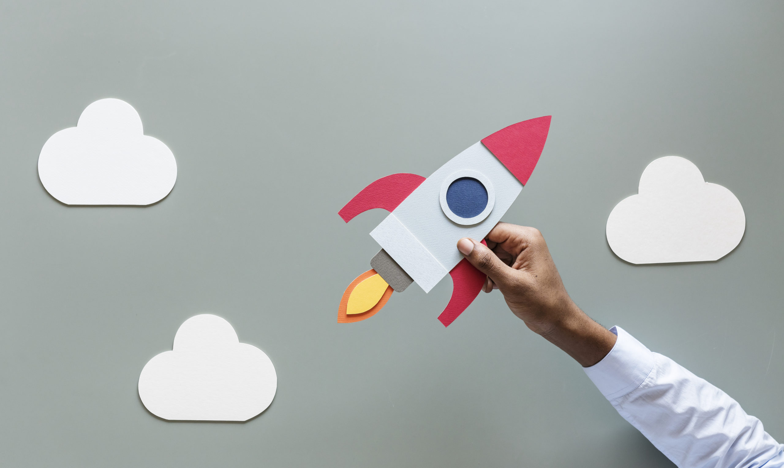 hand holding rocketship startup business pl7qbbu scaled 1